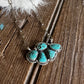 Turquoise stone necklace on a wooden surface