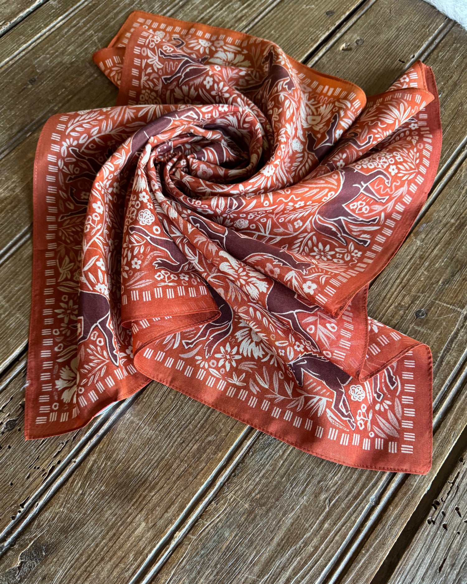 Block Print Horses Shorty Scarf folded on rustic wood background 