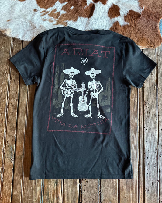 Black t-shirt with skeleton design and 'Ariat' branding on a wooden surface.