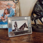 Decorative photo frames on a wooden surface with a horse and rider image.