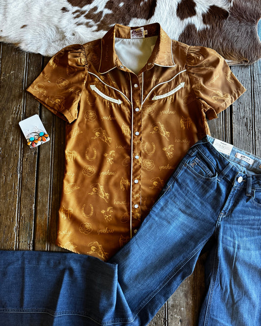 Brown shirt and blue jeans on a wooden surface with cowhide rug