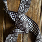 Black and white patterned tie on a wooden surface