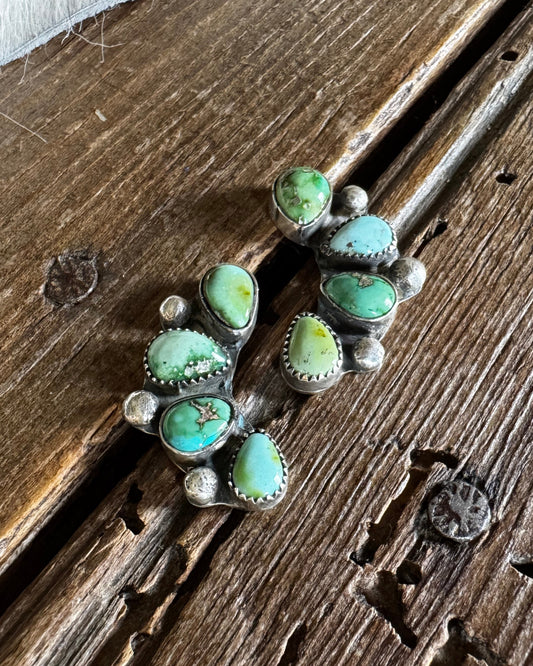 cluster earrings on a wooden surface 