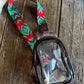 clear stadium bag with a bright aztec strap on a wooden background