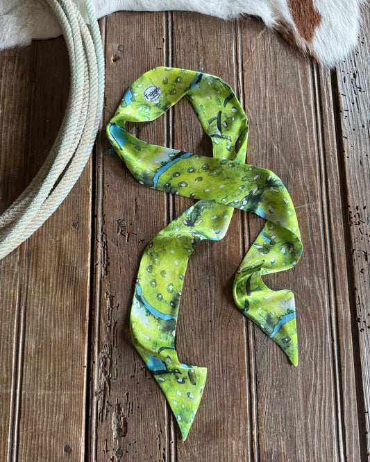 Green cactus patterned scarf on a wooden surface