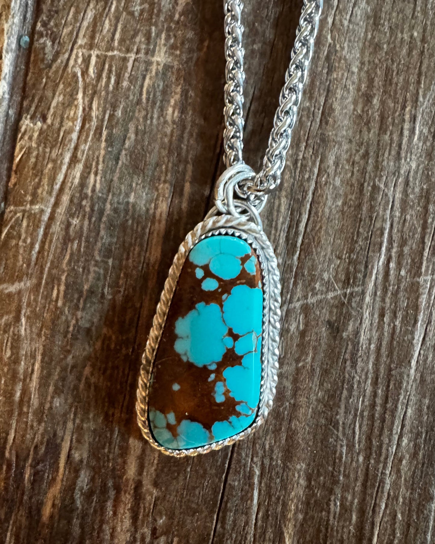 Turquoise stone necklace on a wooden surface