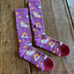 Lucky Unicorns Performance Socks in purple on rustic wood background 
