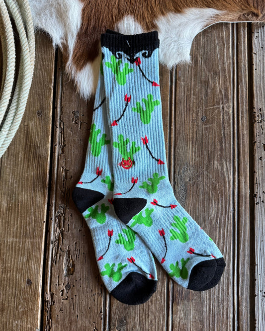Colorful sock with floral pattern on a wooden surface