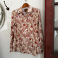 Floral-patterned shirt on a white surface with a red border