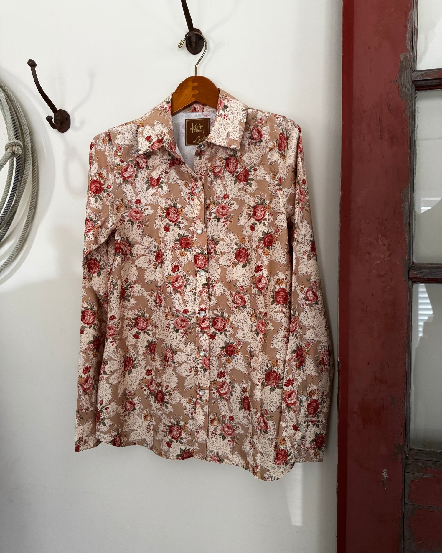 Floral-patterned shirt on a white surface with a red border