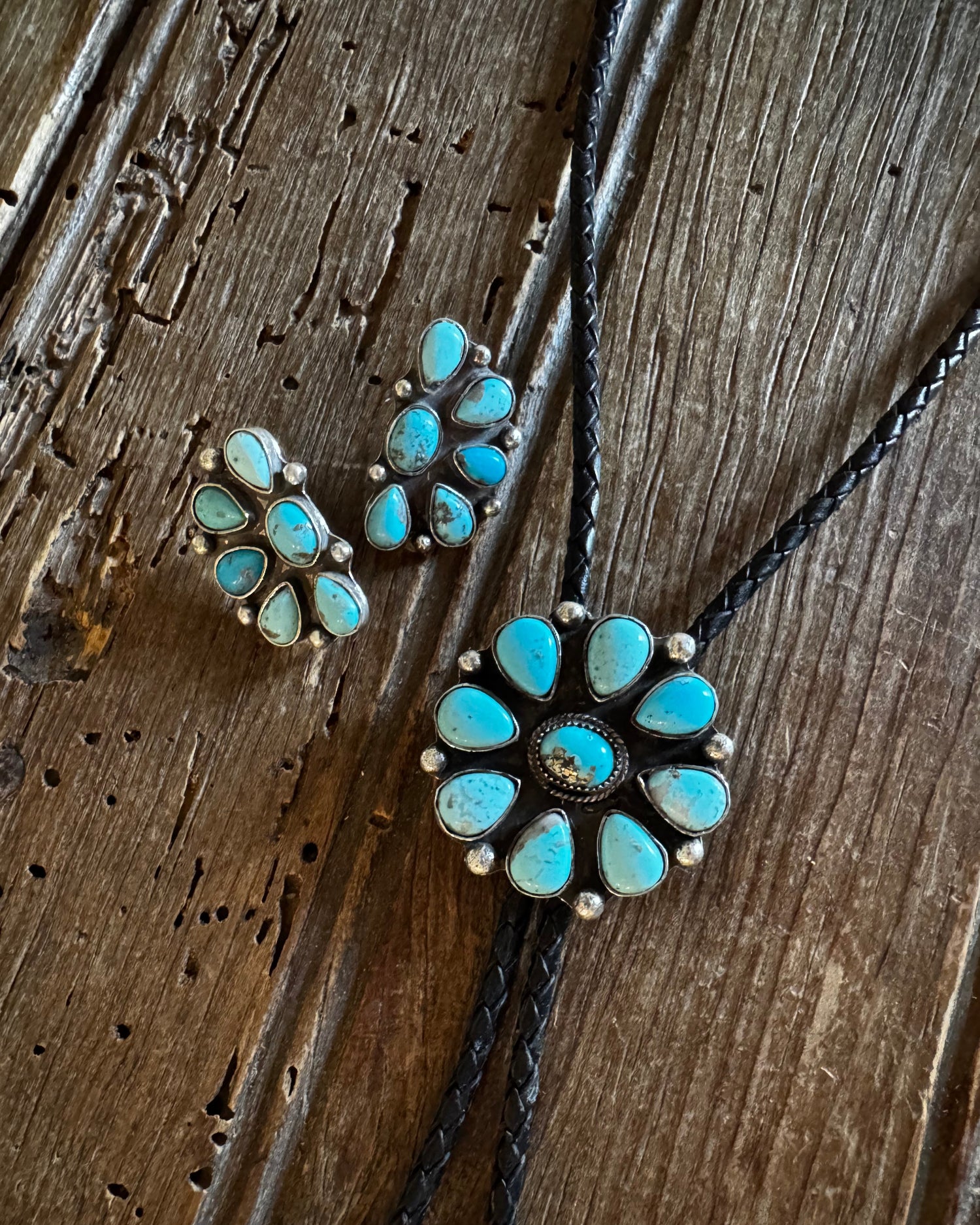Pair of turquoise stone earrings on a wooden surface