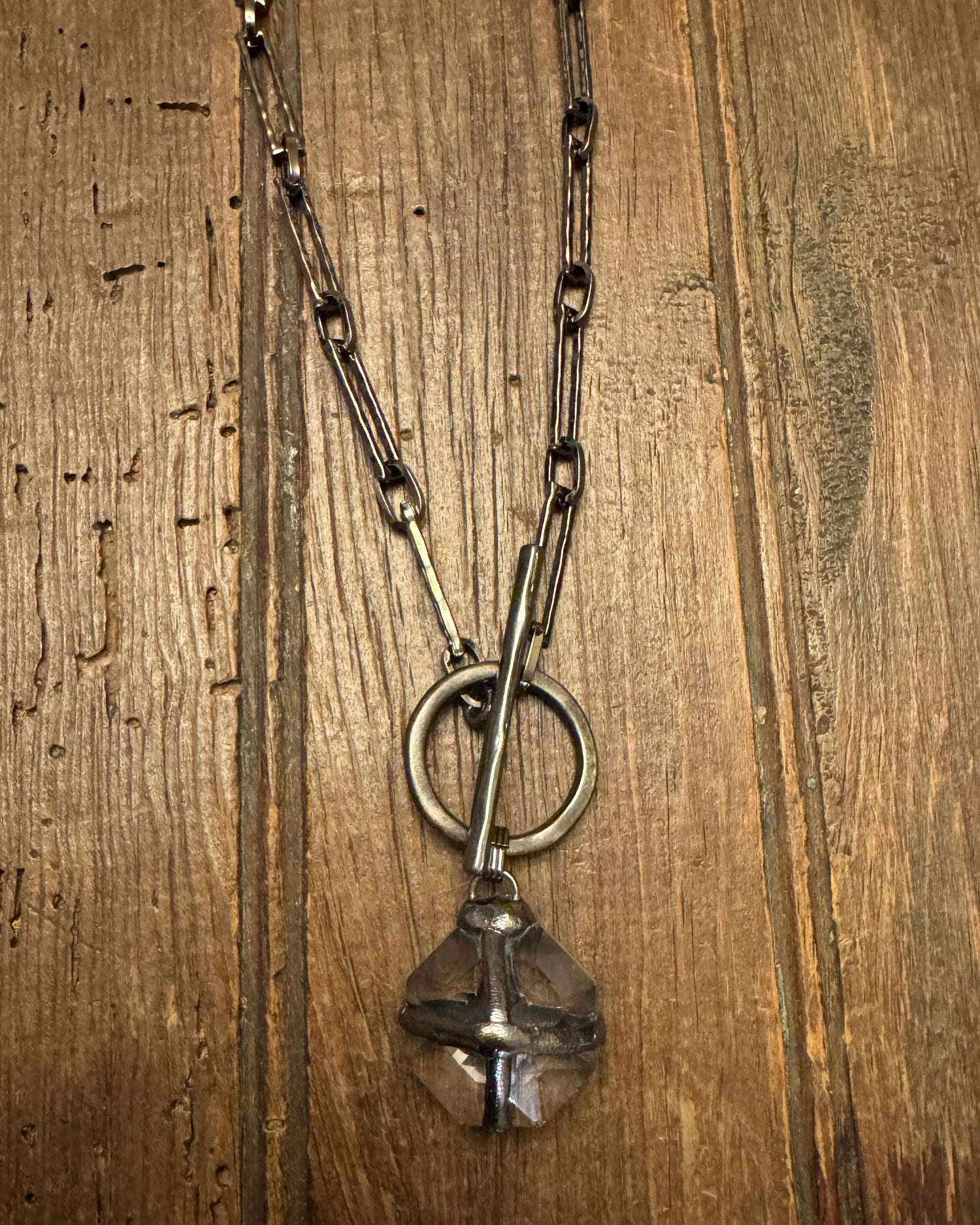 Necklace with a large pendant on a wooden surface