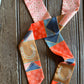 Close up of patchwork twilly scarf on a rustic wooden background