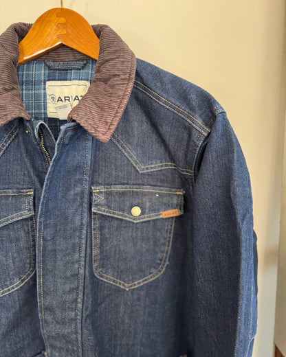 Close up of corduroy collar on a men's denim jacket hanging on a white background