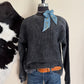 Gray shirt on a mannequin with a cowhide in the background