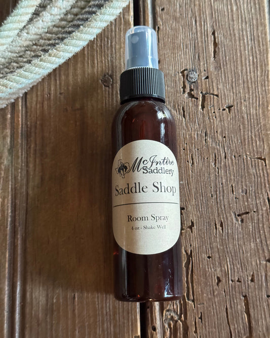 Bottle of saddle soap room spray with a label on a wooden surface