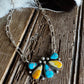 Necklace with a colorful pendant on a wooden surface