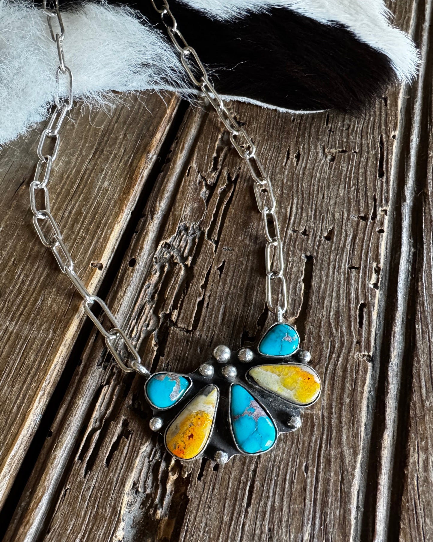 Necklace with a colorful pendant on a wooden surface