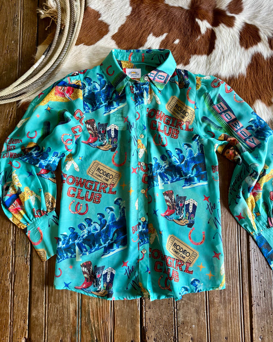 shirt with cowboy-themed print on a wooden surface