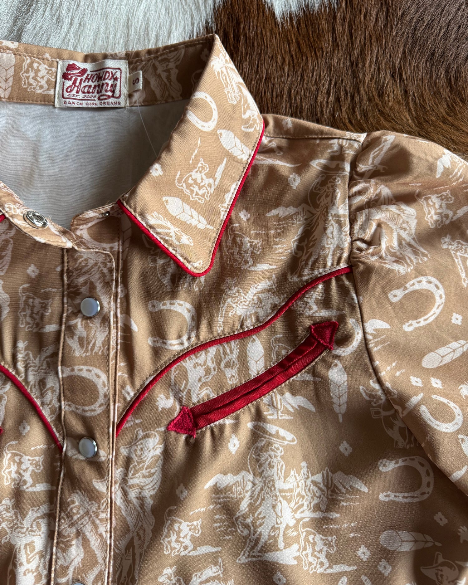 Close-up of a patterned jacket with red accents on a textured surface