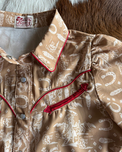 Close-up of a patterned jacket with red accents on a textured surface