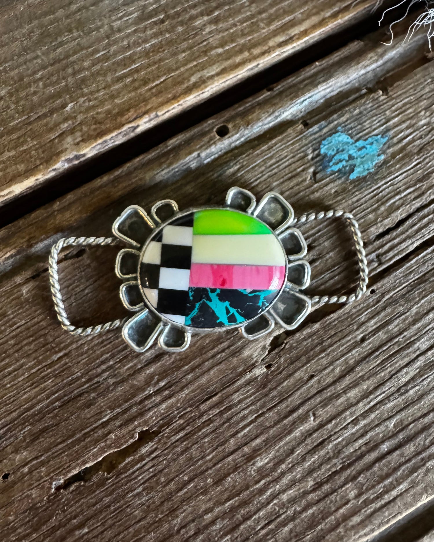Neon checkered pendant on a wooden surface