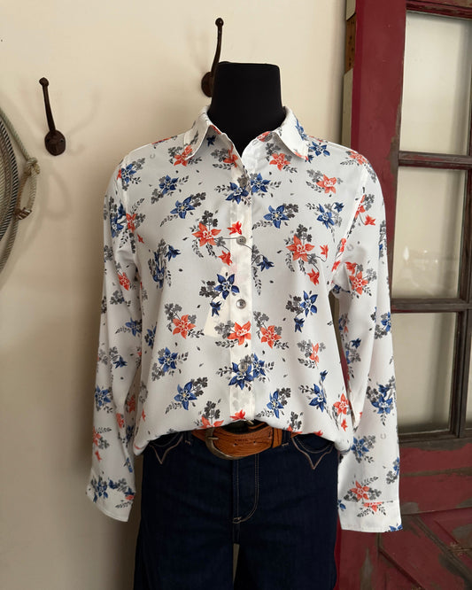 Floral-patterned shirt on a mannequin against a neutral wall.