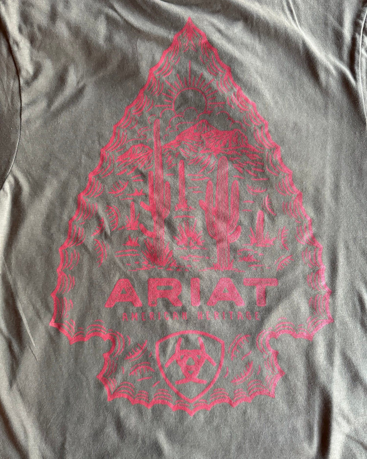 Gray t-shirt with red graphic design and 'Ariat' branding