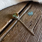Necklace with a pendant on a wooden surface