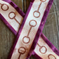 close up of snaffle bit ribbon scarf on wooden background