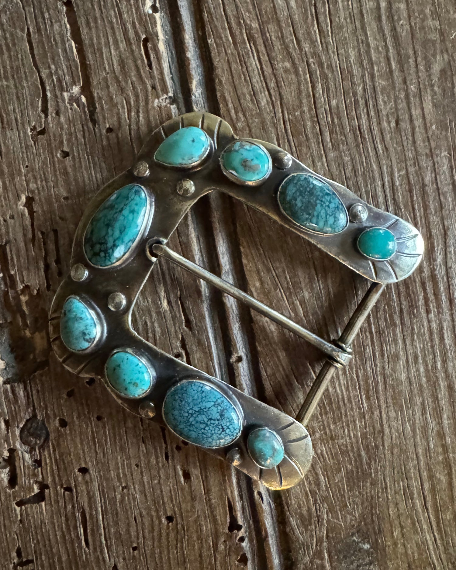 Horse shoe buckle 4 with turquoise on rustic wood background