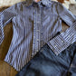 Flat lay of Ivy Pinstripe Frill Shirt with jeans on rustic wood background