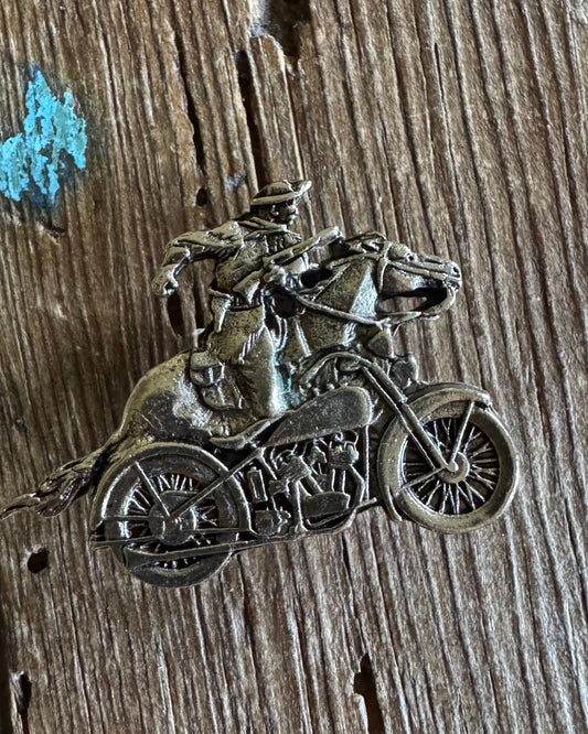 silver motorcycle and horse pin on wooden background 
