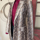 Snakeskin patterned jacket on a mannequin against a neutral background