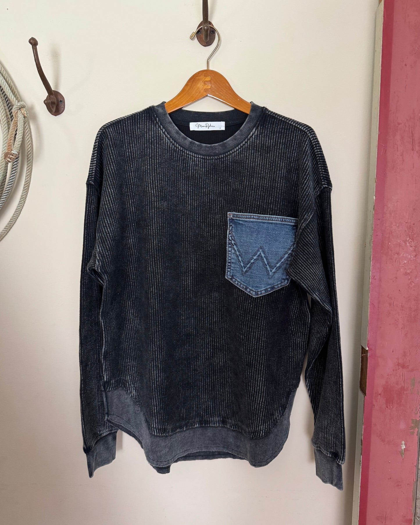 Dark shirt with a patch on a white surface