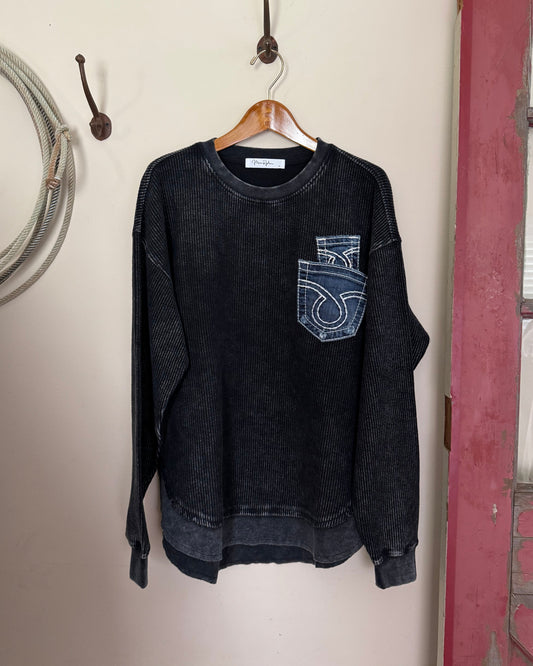 Black sweatshirt with a logo on a white surface