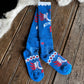 Blue socks with red and white designs on a wooden floor.