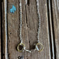 Briarwood Snaffle Bit Necklace on rustic wood background 