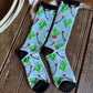 Pair of patterned socks on a wooden floor with a cowhide in the background.