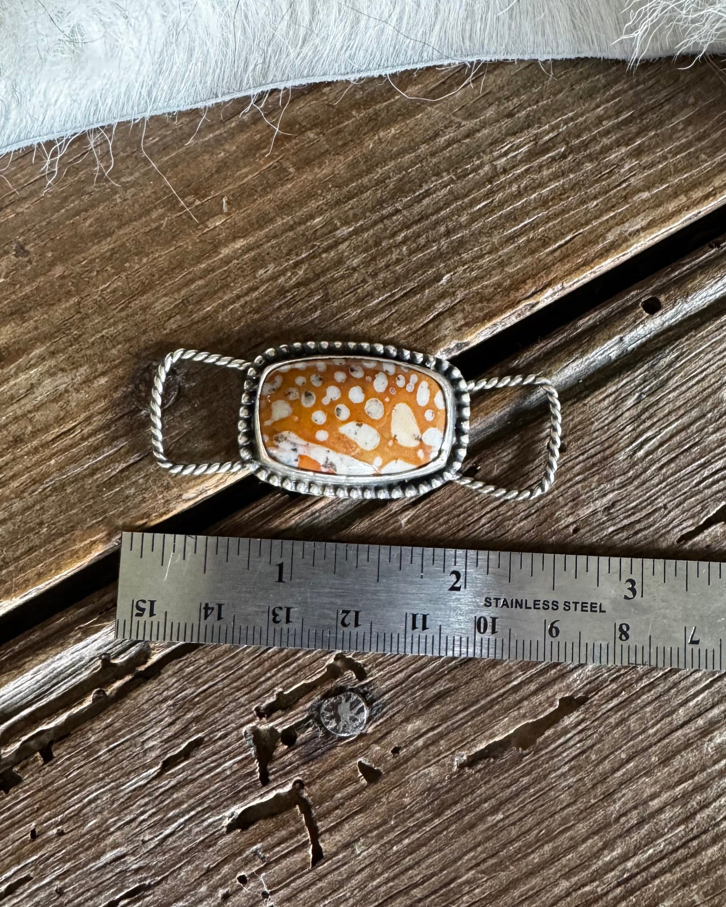 Fawn Jasper twilly slide on a wooden background with a ruler 