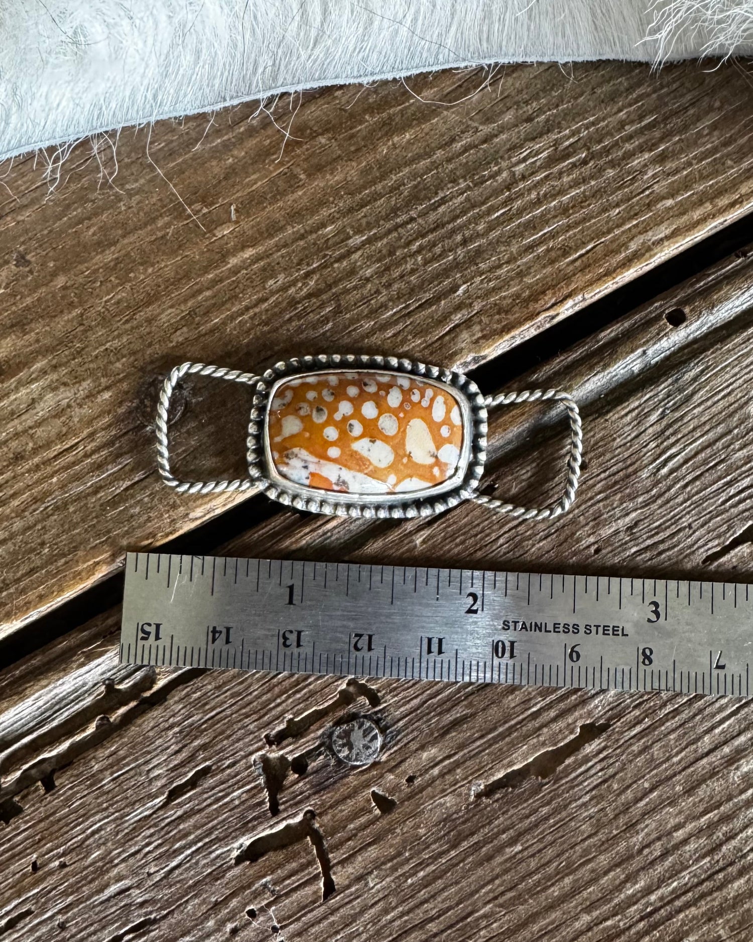 Fawn Jasper twilly slide on a wooden background with a ruler 