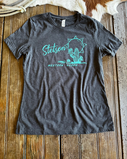 Gray t-shirt with Stetson logo on a wooden surface
