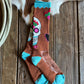 Sock with colorful design on a wooden surface next to a cowhide rug