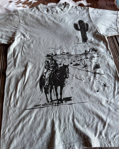 White t-shirt with black graphic design on a wooden surface