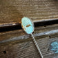 Necklace with a turquoise pendant on a wooden surface