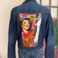 Denim jacket with a colorful graphic design on the back, featuring a woman and horse