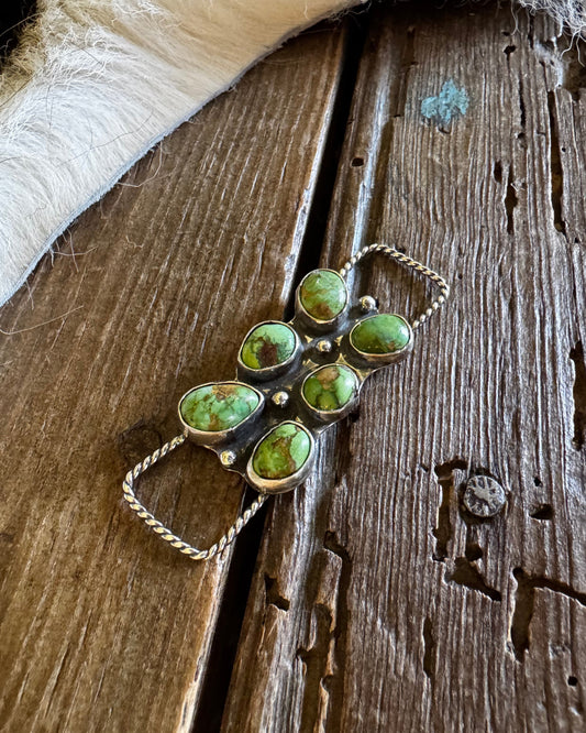 Jewelry with green stones on a wooden surface