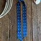 Blue ribbon scarf with white dots on a wooden surface