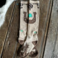 Pair of socks with horseshoe and shamrock design on a wooden surface