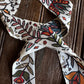 close up of floral twilly scarf on a wooden background